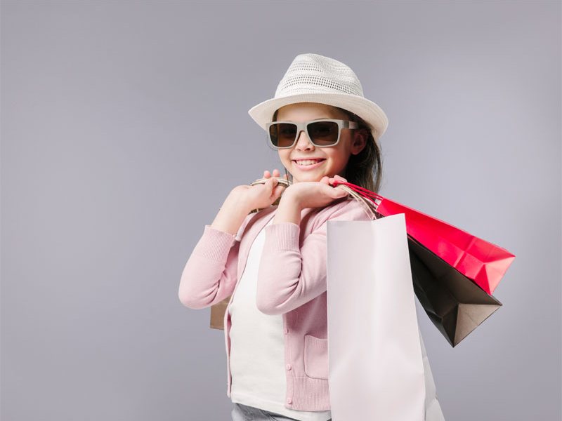 Shopper holding colorful shopping bags